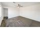 Bright bedroom with gray carpet, en-suite bathroom, and ceiling fan at 4917 E Washington Ave, Las Vegas, NV 89110