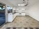 Kitchen with white cabinets, granite countertops, and tiled floors at 4917 E Washington Ave, Las Vegas, NV 89110