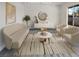 Virtually staged living room featuring beige sofas and a modern coffee table at 4917 E Washington Ave, Las Vegas, NV 89110