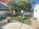 Backyard with playset, artificial turf, and partial pool view at 503 Lariat Ln, Henderson, NV 89014