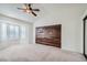 Spacious bedroom with wood accent wall and neutral carpeting at 503 Lariat Ln, Henderson, NV 89014