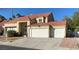 Two-story house with tile roof, three-car garage, and landscaped front yard at 503 Lariat Ln, Henderson, NV 89014