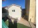 White storage shed with patio furniture and landscaping at 503 Lariat Ln, Henderson, NV 89014