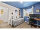 Cozy bedroom with a daybed, workspace, and blue accent wall at 531 Thistleberry Ave, Henderson, NV 89044