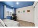 Cozy bedroom with a bed, desk, and blue accent wall at 531 Thistleberry Ave, Henderson, NV 89044