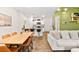 Open concept dining area with kitchen view, wood table and leather chairs at 531 Thistleberry Ave, Henderson, NV 89044