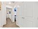 Bright hallway with doors to bedrooms and a linen closet at 531 Thistleberry Ave, Henderson, NV 89044