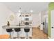 Modern kitchen with white cabinets, granite counters, and island seating at 531 Thistleberry Ave, Henderson, NV 89044