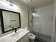 Modern bathroom with white subway tile, glass shower, and floating vanity at 5640 Judith Resnik Ct, Las Vegas, NV 89103