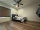 Bedroom with ceiling fan, window blinds, and wood-look floors at 5640 Judith Resnik Ct, Las Vegas, NV 89103