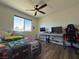 Bedroom with large window, ceiling fan, and workspace at 5640 Judith Resnik Ct, Las Vegas, NV 89103