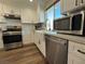 Modern kitchen with white cabinets, farmhouse sink, and stainless steel appliances at 5640 Judith Resnik Ct, Las Vegas, NV 89103