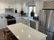 Modern kitchen with white cabinets, quartz countertops, and stainless steel appliances at 5640 Judith Resnik Ct, Las Vegas, NV 89103