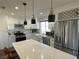 Modern kitchen with white shaker cabinets, quartz countertops and stainless steel appliances at 5640 Judith Resnik Ct, Las Vegas, NV 89103