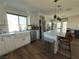 Modern kitchen with white cabinets, quartz countertops, and a farmhouse sink at 5640 Judith Resnik Ct, Las Vegas, NV 89103