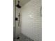 Walk-in shower with subway tile and pebble floor at 5640 Judith Resnik Ct, Las Vegas, NV 89103