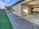 Covered patio, grassy area, and brick pavers at 5932 Quintillion Ave, Las Vegas, NV 89122