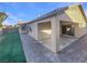 Covered patio, grassy area, and brick pavers at 5932 Quintillion Ave, Las Vegas, NV 89122