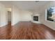 Bright living room featuring hardwood floors and a corner fireplace at 5932 Quintillion Ave, Las Vegas, NV 89122