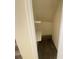 Small under-stair storage closet with white shelves at 6124 Jones Cir, Las Vegas, NV 89107