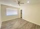 Bright bedroom with wood-look floors and ceiling fan at 6124 Jones Cir, Las Vegas, NV 89107