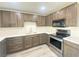 Modern kitchen with dark brown cabinets, stainless steel appliances, and quartz countertops at 6124 Jones Cir, Las Vegas, NV 89107