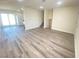 Open living area with gray vinyl flooring and kitchen views at 6124 Jones Cir, Las Vegas, NV 89107