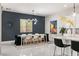 Bright dining room with modern chandelier and seating for six at 6188 Rockville Creek Ct, Las Vegas, NV 89149