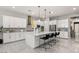 Modern kitchen with white cabinets and breakfast bar at 6188 Rockville Creek Ct, Las Vegas, NV 89149