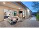 Evening view of covered patio with seating area and exterior lighting at 6188 Rockville Creek Ct, Las Vegas, NV 89149