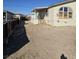 Tan mobile home with covered porch and large windows, side yard view at 6214 Mount Rainier Ave, Las Vegas, NV 89156