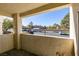 Balcony view shows parking area and the surrounding buildings and trees with a clear blue sky at 698 S Racetrack Rd # 711, Henderson, NV 89015