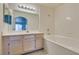 Bright bathroom with a tub, tiled walls and floors, a broad mirror, and a modern vanity at 698 S Racetrack Rd # 711, Henderson, NV 89015