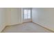 A bedroom with neutral carpeting, a window with blinds, and a closet door at 698 S Racetrack Rd # 711, Henderson, NV 89015