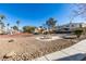 Community courtyard featuring manicured landscaping, picnic tables, and walkways amidst residential buildings at 698 S Racetrack Rd # 711, Henderson, NV 89015