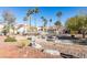 Community courtyard featuring manicured landscaping, picnic tables, and walkways amidst residential buildings at 698 S Racetrack Rd # 711, Henderson, NV 89015