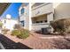 Condominium exterior with desert landscaping and an outdoor patio area on the lower level at 698 S Racetrack Rd # 711, Henderson, NV 89015