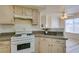 A bright kitchen showcases tile floors, granite counters, and white appliances at 698 S Racetrack Rd # 711, Henderson, NV 89015