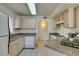 Bright kitchen with light wood cabinets, granite countertops, and white appliances at 698 S Racetrack Rd # 711, Henderson, NV 89015