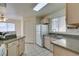 Bright kitchen featuring neutral decor, standard white appliances, and stylish tile flooring at 698 S Racetrack Rd # 711, Henderson, NV 89015