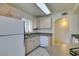 Efficient kitchen featuring light wood cabinets, granite counters, and white appliances at 698 S Racetrack Rd # 711, Henderson, NV 89015