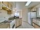 Bright kitchen with white appliances and light wood cabinets at 698 S Racetrack Rd # 711, Henderson, NV 89015