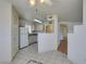 Bright kitchen featuring neutral walls, standard white appliances, and stylish tile flooring at 698 S Racetrack Rd # 711, Henderson, NV 89015