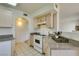 A bright kitchen showcases tile floors, granite counters and white appliances at 698 S Racetrack Rd # 711, Henderson, NV 89015