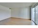 Bright living room with light laminate flooring and sliding glass door to patio at 698 S Racetrack Rd # 711, Henderson, NV 89015