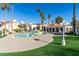 Community swimming pool with palm trees, manicured landscaping, and residential buildings in the background at 698 S Racetrack Rd # 711, Henderson, NV 89015