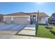 Single-story home with three-car garage, artificial turf, and nicely landscaped front yard at 7291 Purple Shadow Ave, Las Vegas, NV 89113