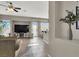 Living area with view of kitchen, fireplace and neutral color scheme at 7291 Purple Shadow Ave, Las Vegas, NV 89113