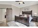 Main bedroom with barn door, dark wood furniture, and ceiling fan at 7291 Purple Shadow Ave, Las Vegas, NV 89113