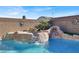 Rock waterfall feature flows into the refreshing pool at 7291 Purple Shadow Ave, Las Vegas, NV 89113